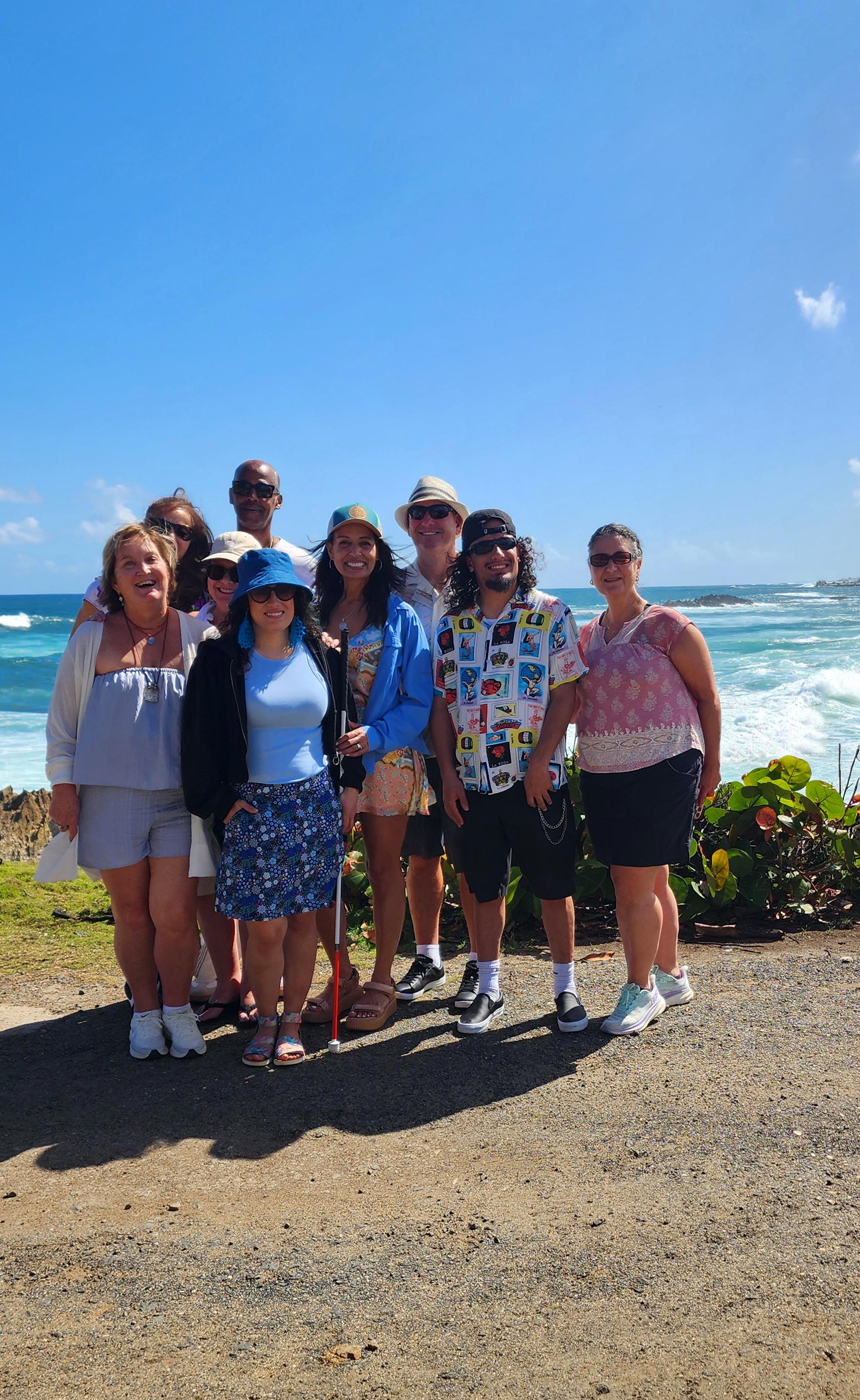 Travelers admiring the Atlantic Ocean views from a historic sentry box in San Juan.