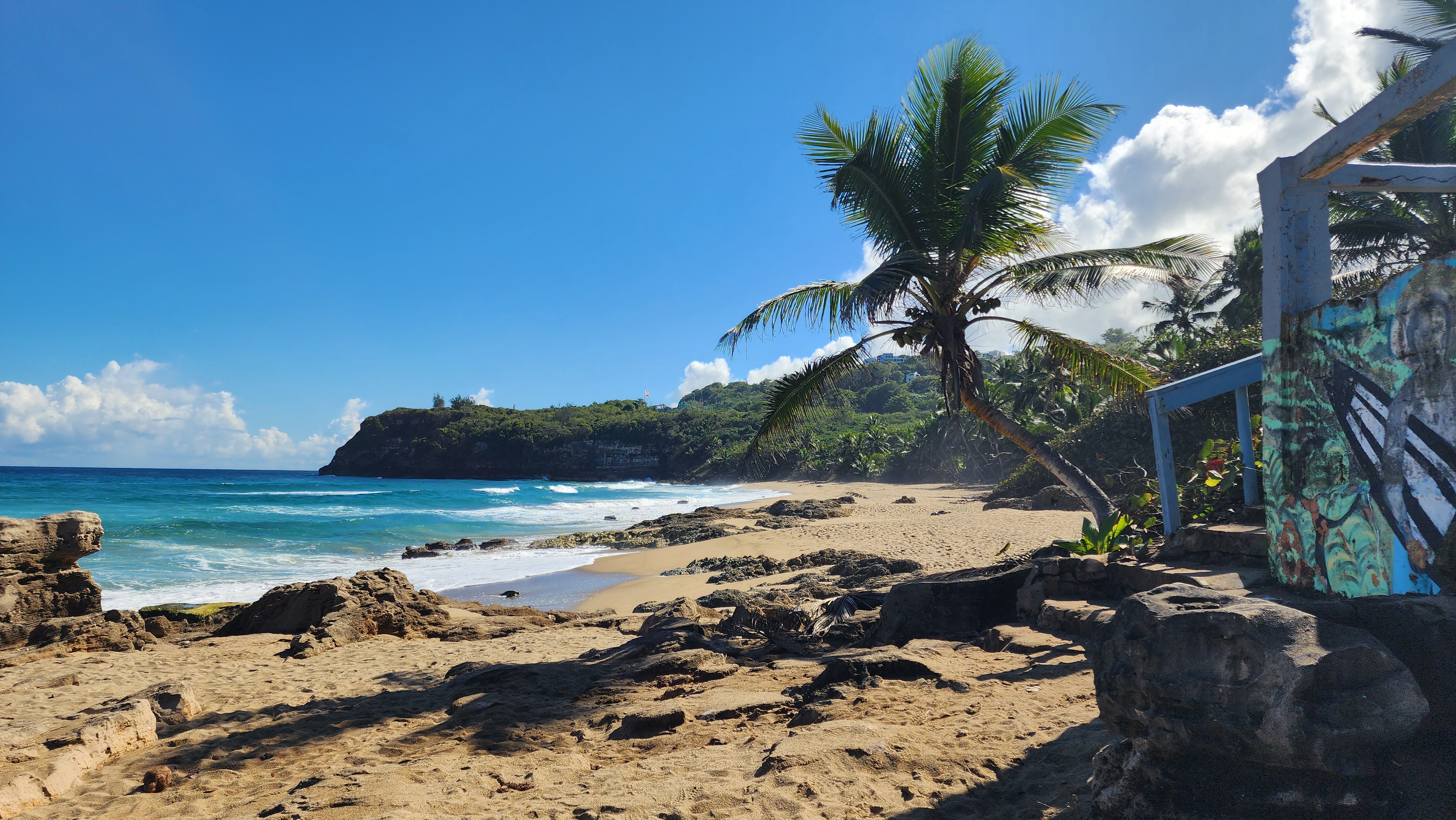 Panoramic scenic overlook on Puerto Rico's north coast at golden hour with travelers admiring the view