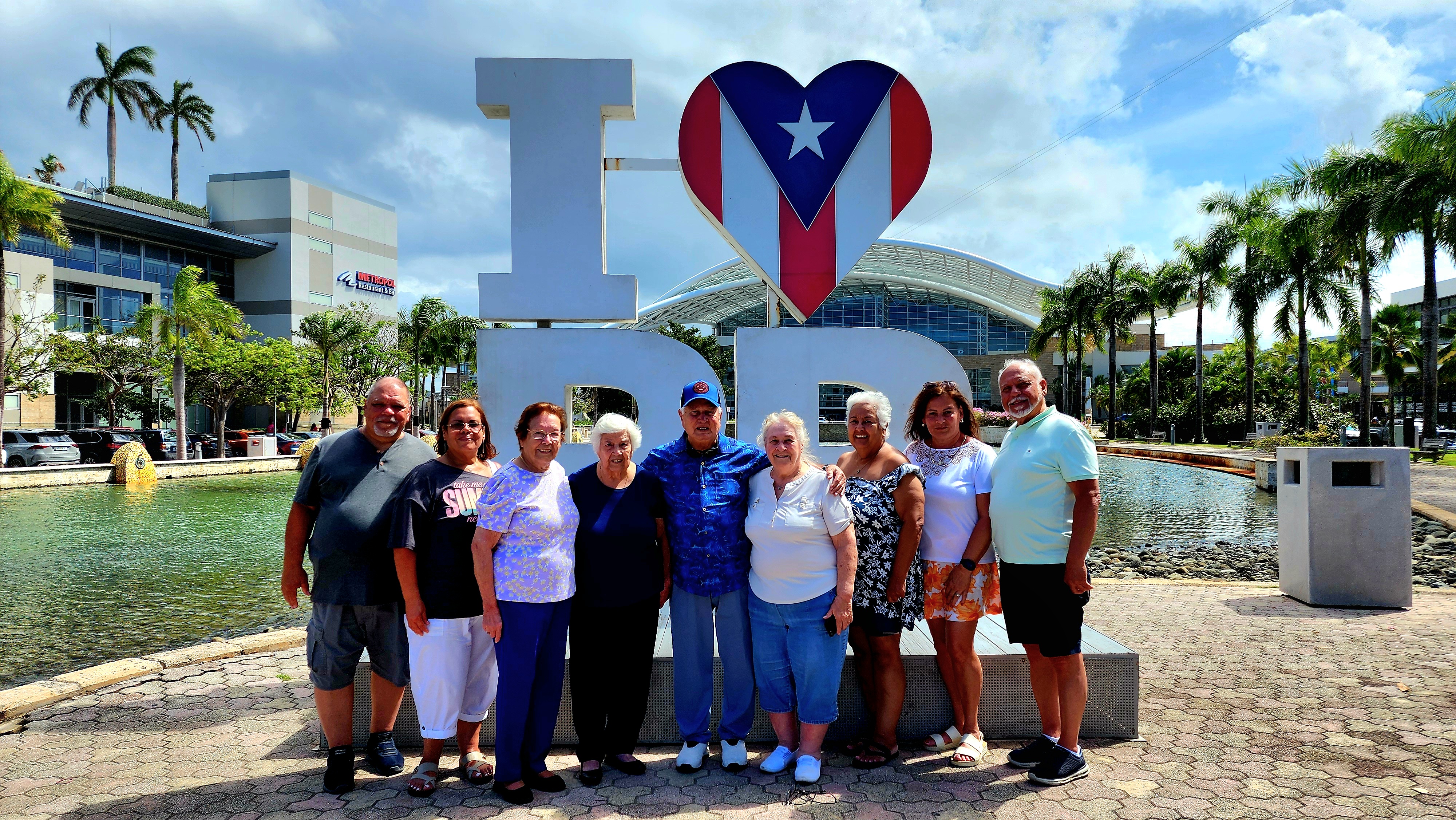 Travelers photographed against the vibrant colors of Puerto Rico's colonial capital.