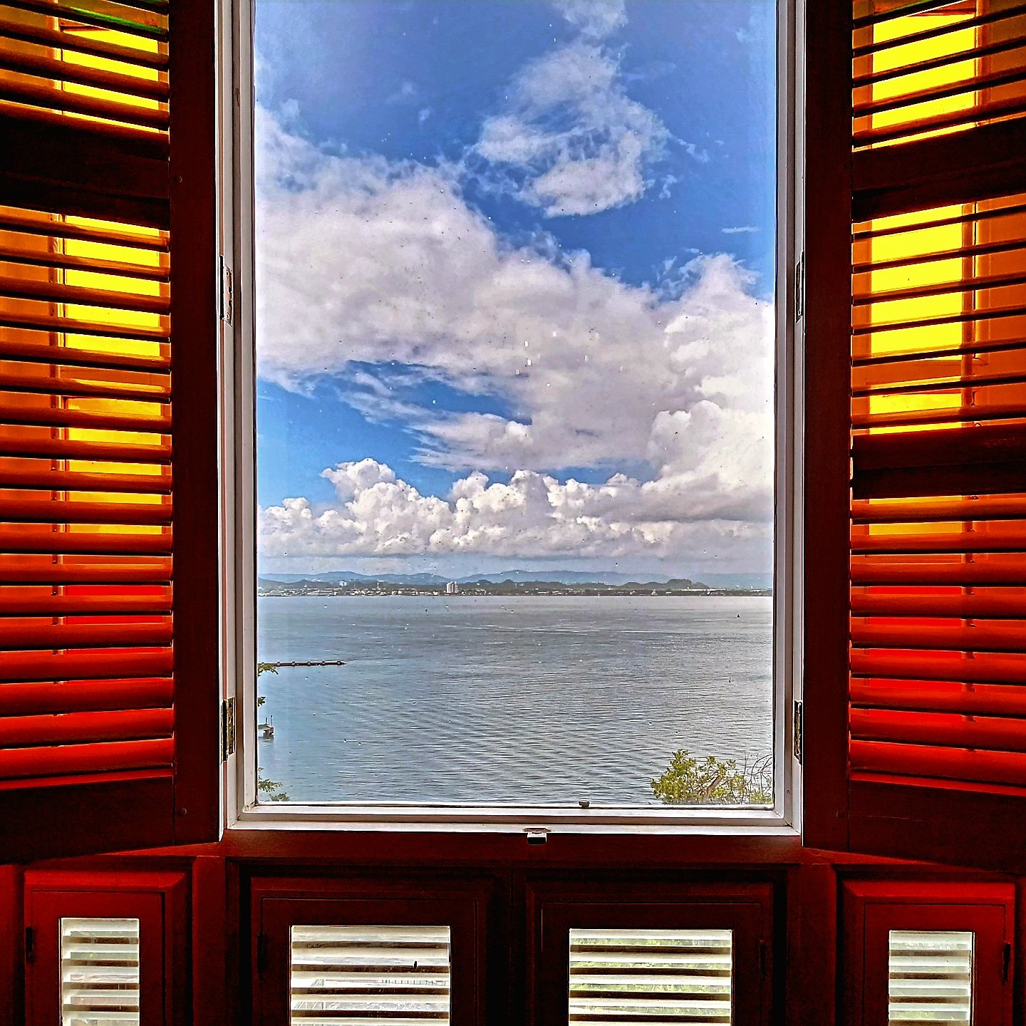 Colorful colonial facade with red shutters near the San Juan waterfront